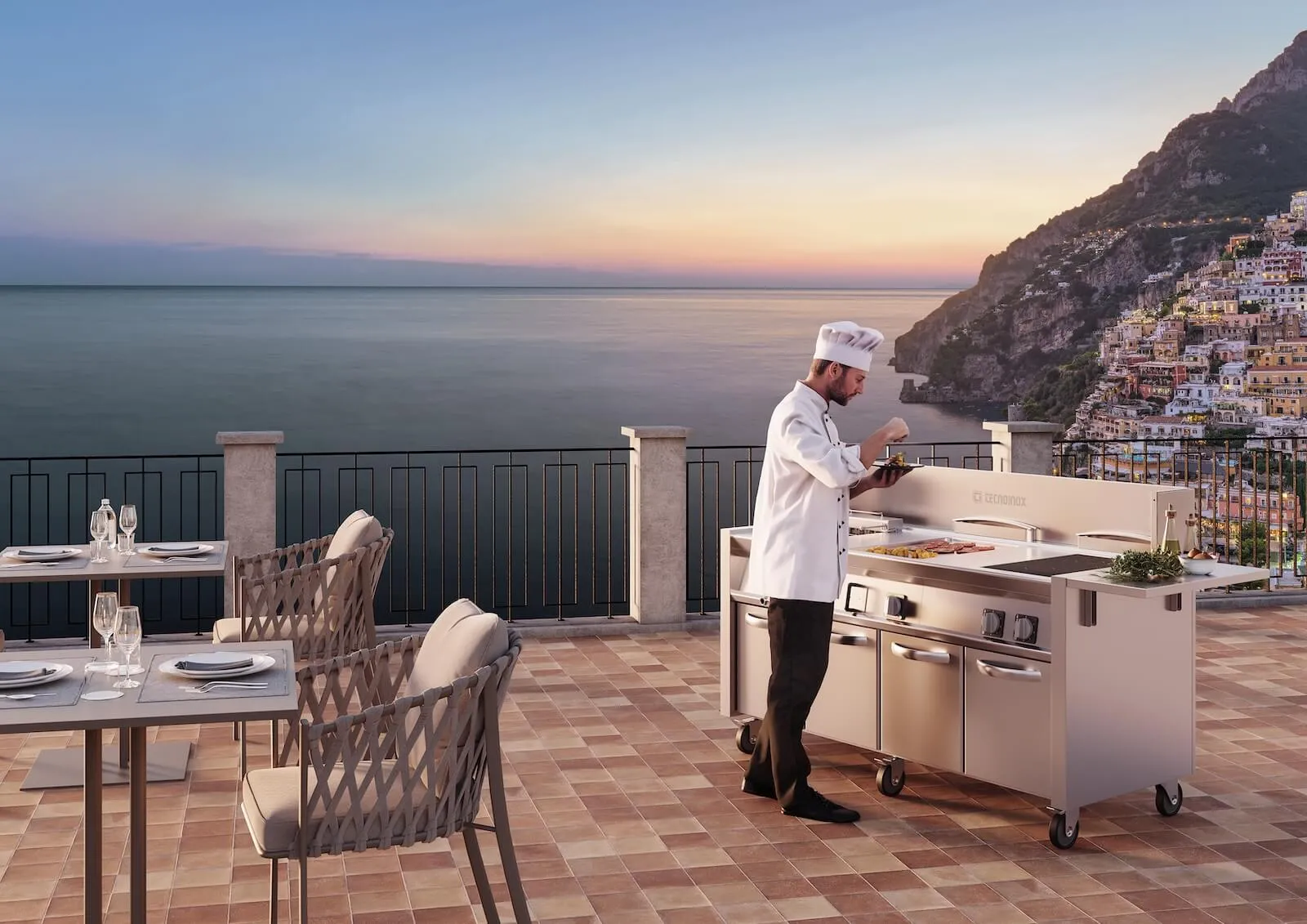 Chef trabajando con una cocina Itineris en una terraza frente al mar